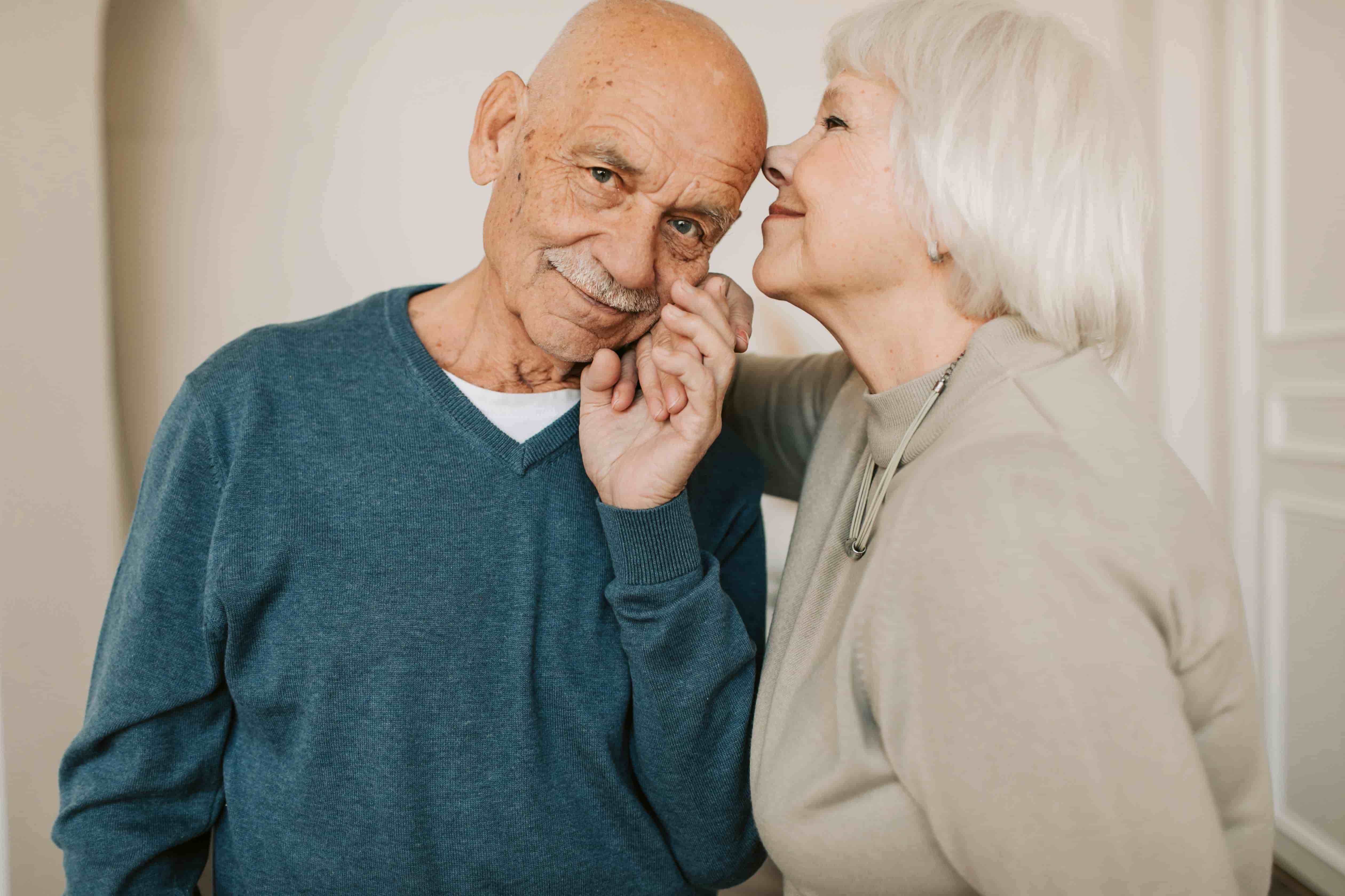 An older couple expressing warmth and support, representing compassion and human connection.
